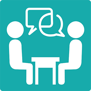 Icon of 2 people talking at a table